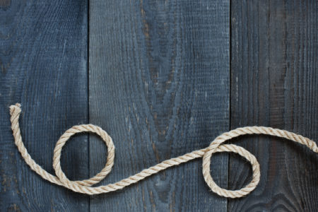 Twisted Rope On The Old Wooden Background