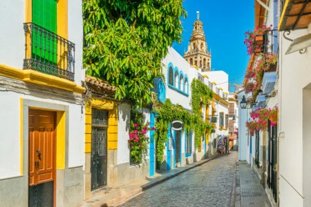 Scenic Sight In The Picturesque Cordoba Jewish Quarter With The Bell Tower Of The Mosque Cathedral. Andalusia, Spain.